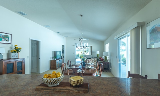 dining area with vaulted ceiling and a chandelier