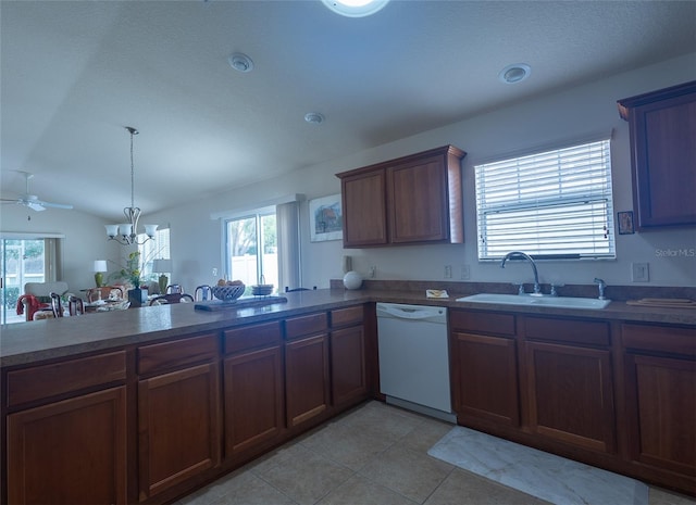 kitchen featuring kitchen peninsula, hanging light fixtures, light tile patterned floors, white dishwasher, and sink