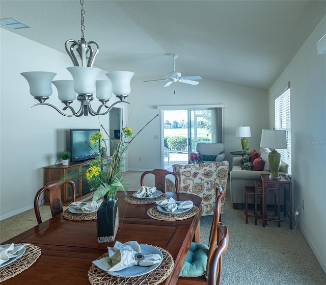 dining room with carpet flooring, lofted ceiling, a wealth of natural light, and ceiling fan with notable chandelier