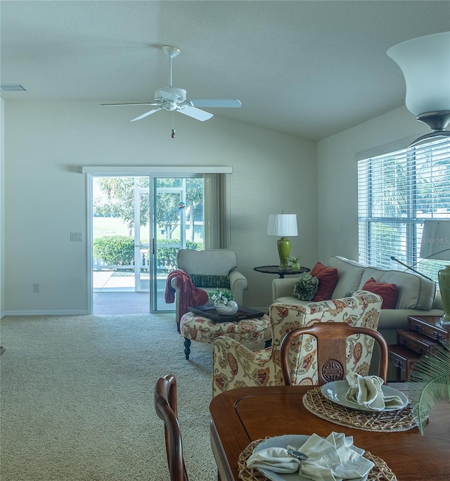 carpeted living room with ceiling fan, a healthy amount of sunlight, and vaulted ceiling