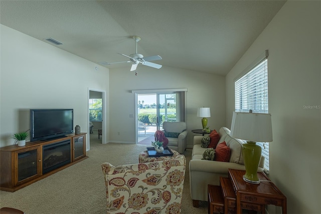 carpeted living room featuring ceiling fan and lofted ceiling