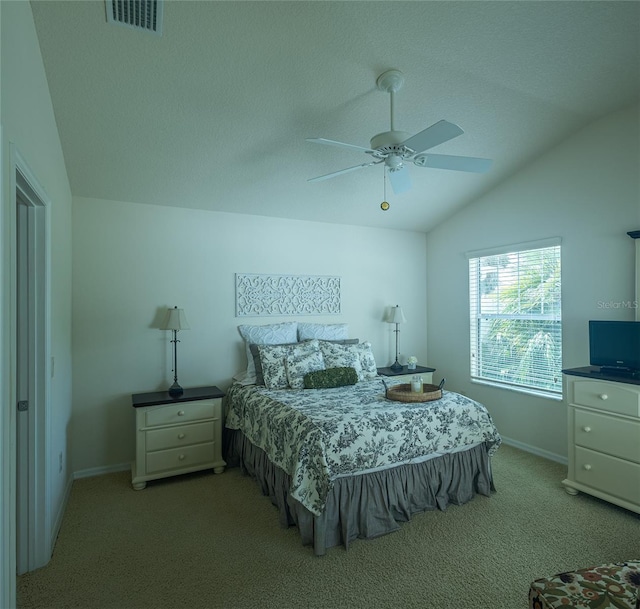 bedroom featuring ceiling fan, light carpet, and vaulted ceiling