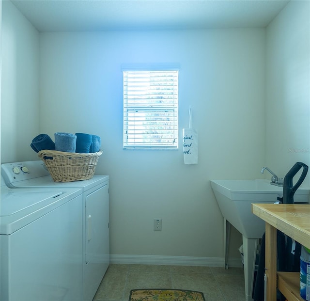 clothes washing area with sink, independent washer and dryer, and light tile patterned flooring