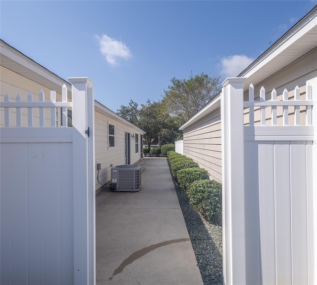 view of property exterior with cooling unit and a patio