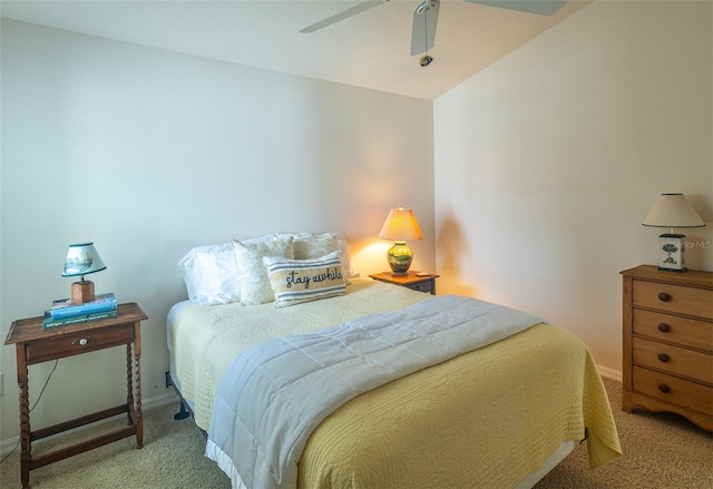 carpeted bedroom with vaulted ceiling and ceiling fan