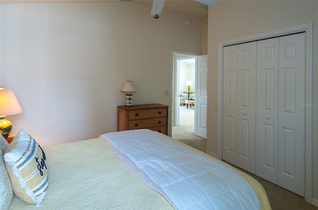 carpeted bedroom with a towering ceiling, a closet, and beam ceiling