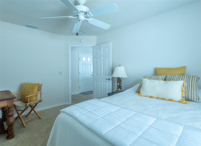 carpeted bedroom featuring a textured ceiling and ceiling fan