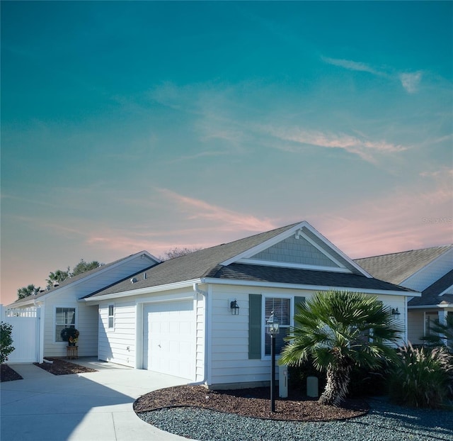 1750 Kingfisher Ct, The Villages, FL 32162 - ranch-style home with concrete driveway, an attached garage, roof with shingles, and fence