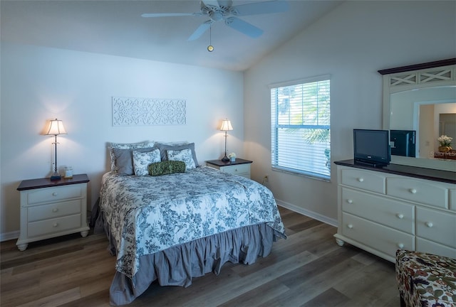 bedroom with dark hardwood / wood-style flooring, vaulted ceiling, and ceiling fan