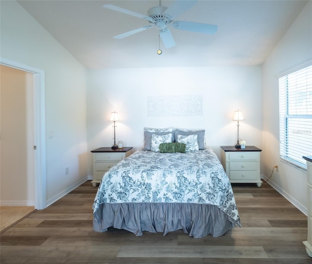 bedroom with ceiling fan, wood-type flooring, and vaulted ceiling