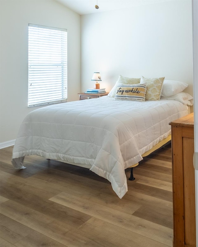 bedroom with hardwood / wood-style floors