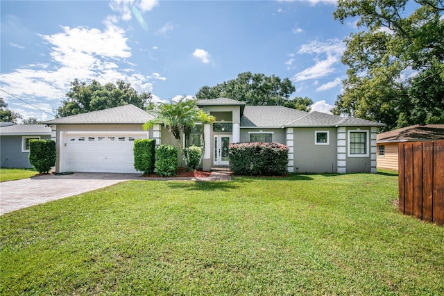 view of front of property with a front yard and a garage