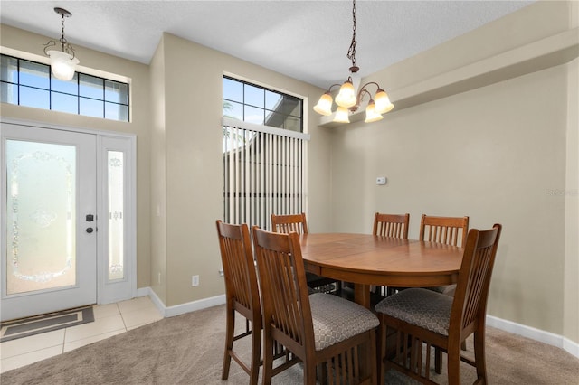 dining room featuring a notable chandelier, light tile patterned floors, and a textured ceiling