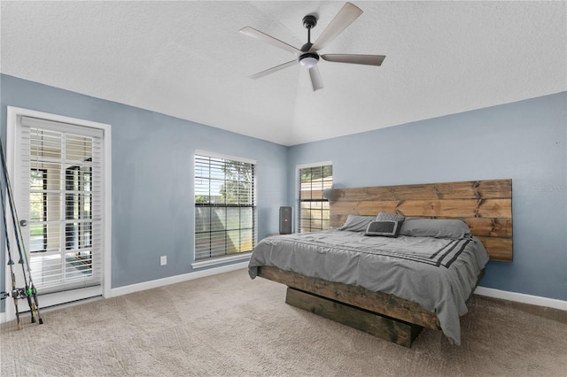 carpeted bedroom with ceiling fan and a textured ceiling