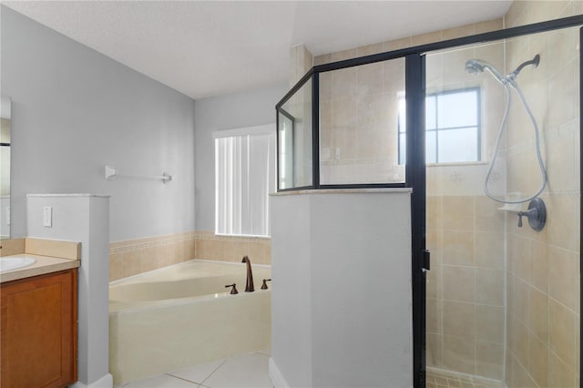 bathroom featuring tile patterned flooring, vanity, and shower with separate bathtub