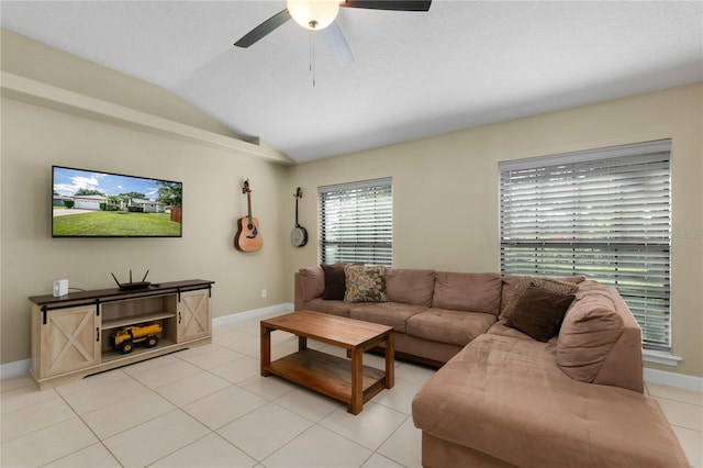 tiled living room with ceiling fan and lofted ceiling