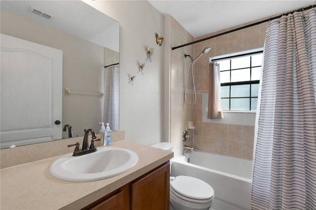 full bathroom with vanity, toilet, and shower / bath combo with shower curtain