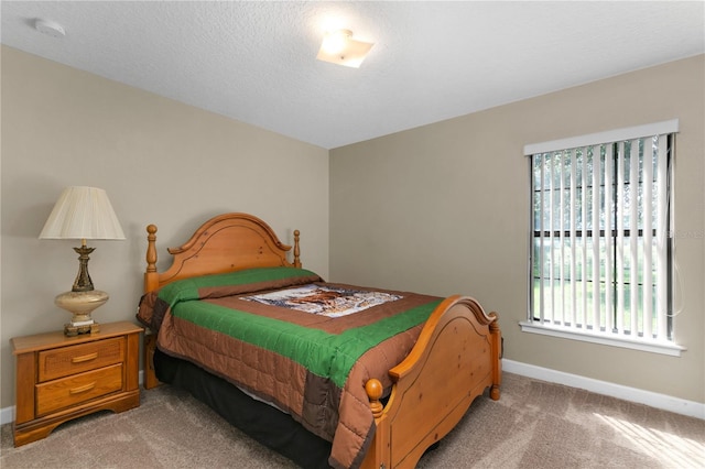 carpeted bedroom with a textured ceiling