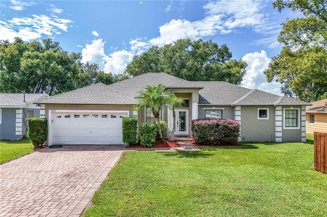 ranch-style house with a garage and a front lawn