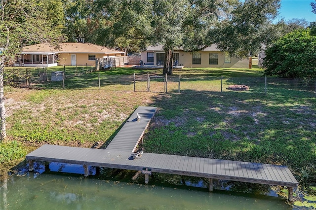 view of yard with a boat dock and a water view