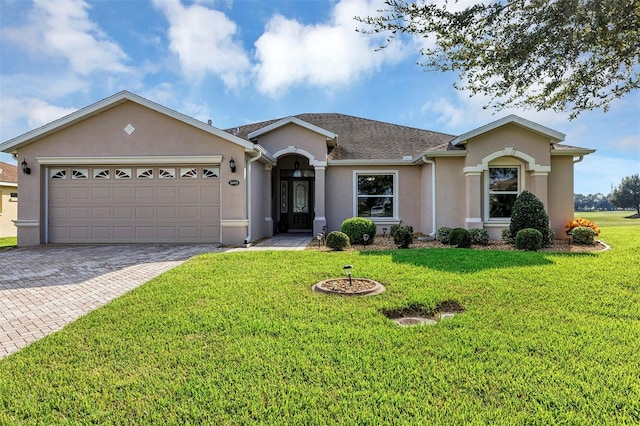 single story home featuring a garage and a front lawn