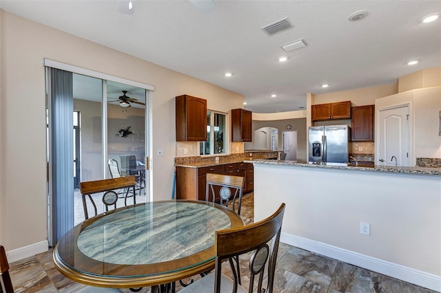 dining area featuring ceiling fan and a textured ceiling