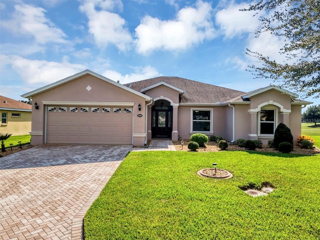 ranch-style home with a garage and a front lawn