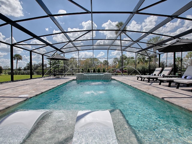 view of swimming pool with a lanai, pool water feature, and a patio