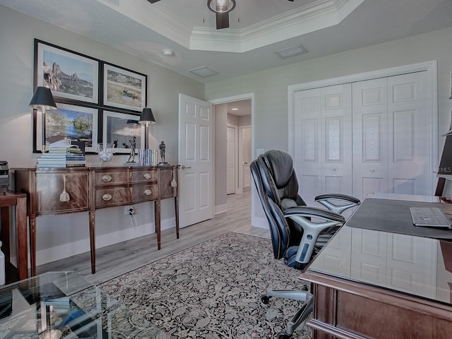 office with a raised ceiling, ceiling fan, light wood-type flooring, a textured ceiling, and ornamental molding