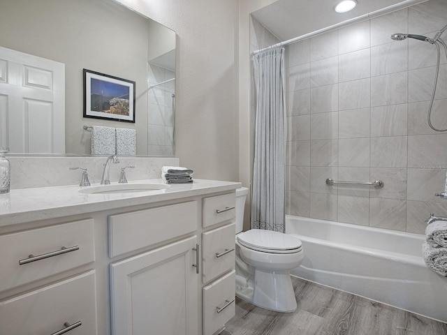 full bathroom featuring hardwood / wood-style flooring, shower / bath combo, toilet, and vanity