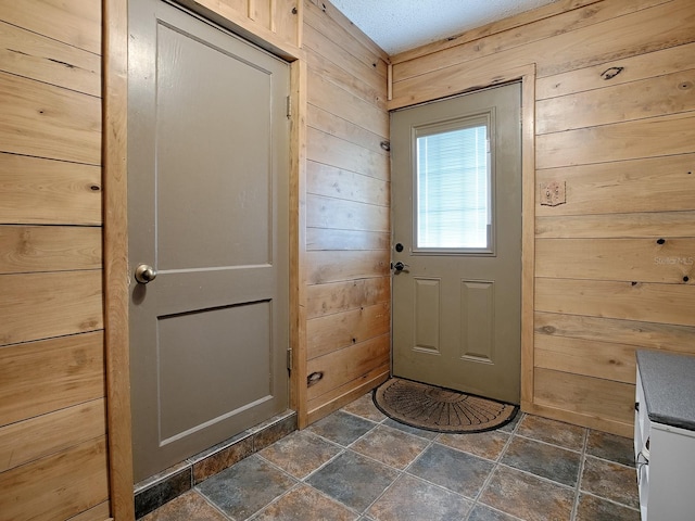 doorway with wood walls