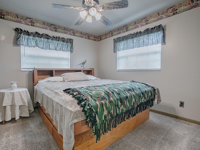 bedroom with ceiling fan, carpet flooring, and multiple windows