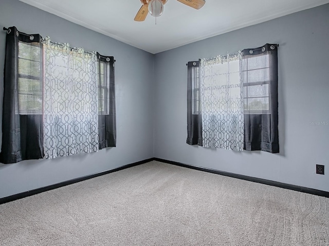 empty room with carpet flooring and ceiling fan