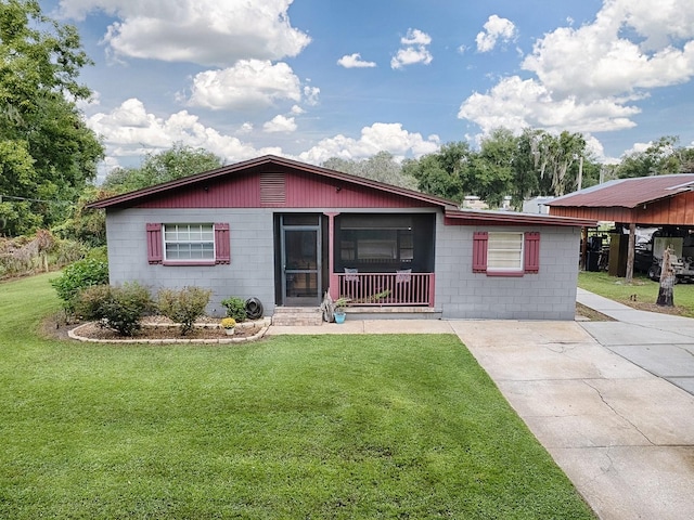 ranch-style home with a carport and a front lawn