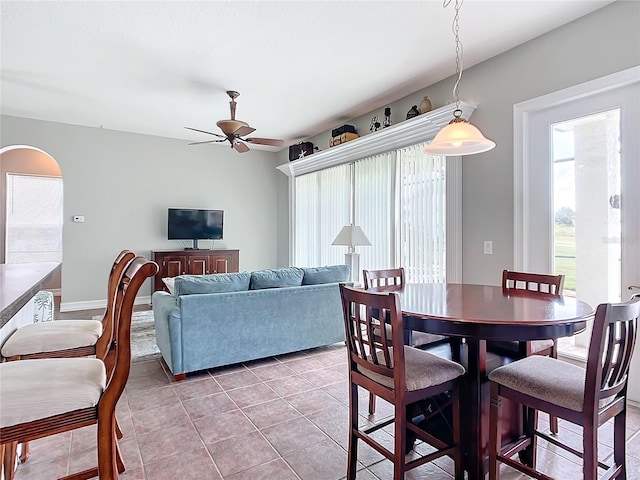 tiled dining area featuring ceiling fan