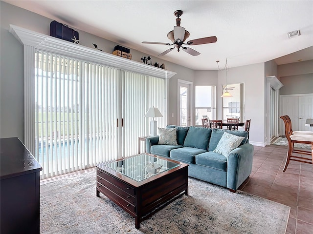 living room featuring tile patterned floors and ceiling fan