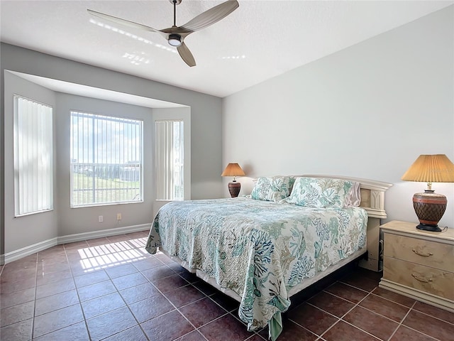 bedroom featuring ceiling fan and dark tile patterned floors