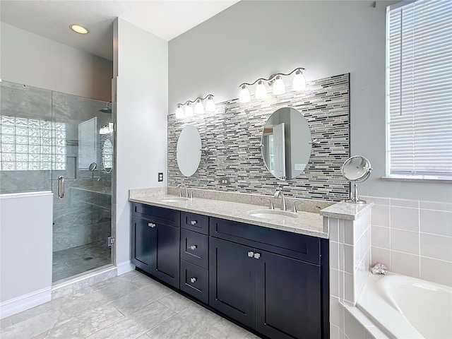 bathroom with plenty of natural light, separate shower and tub, and vanity