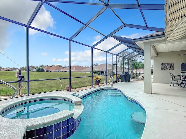 view of pool with a lanai, an in ground hot tub, a yard, and a patio