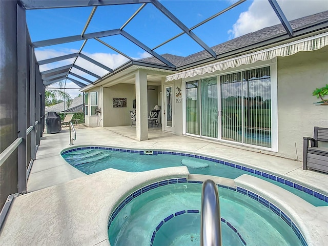 view of pool featuring a lanai, a patio area, and an in ground hot tub