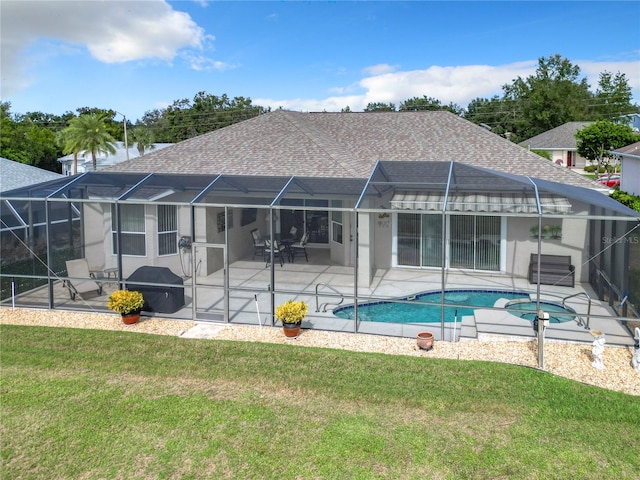 back of house with a yard, a patio, and glass enclosure