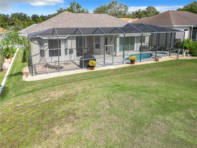 rear view of house with a lanai, a yard, and a patio