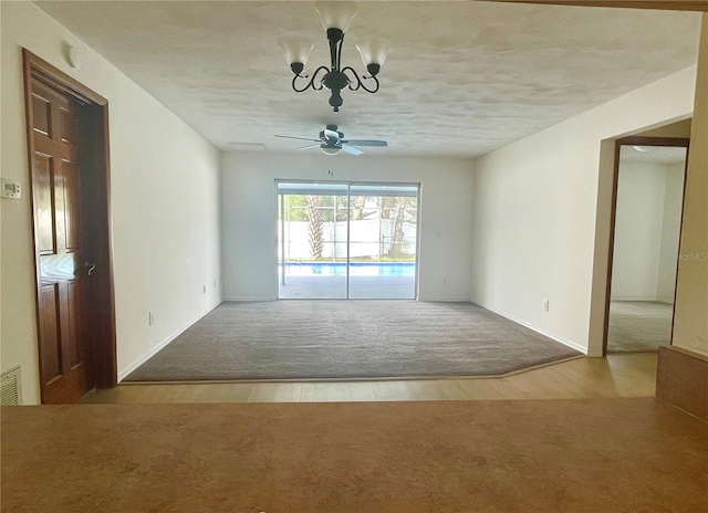 unfurnished room featuring wood-type flooring, a textured ceiling, and ceiling fan