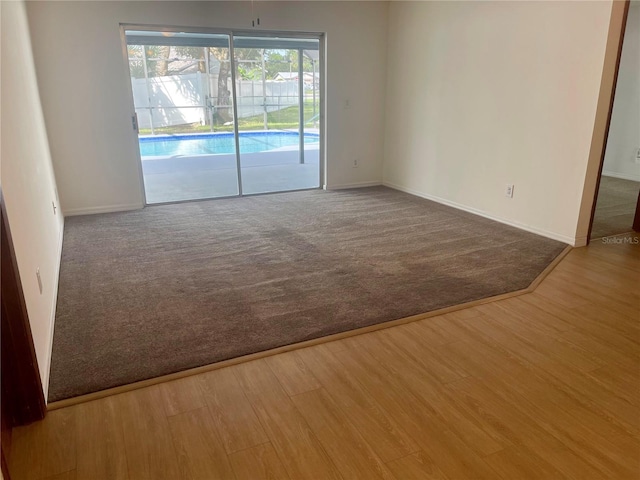 spare room with hardwood / wood-style flooring