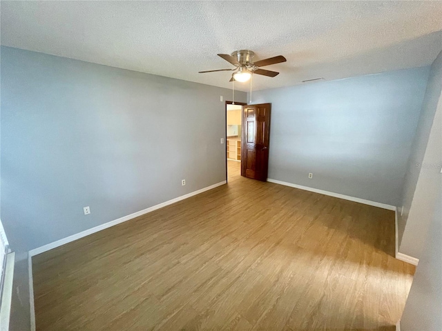 spare room with wood-type flooring, a textured ceiling, and ceiling fan