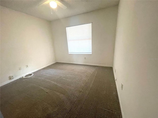 carpeted empty room featuring a textured ceiling and ceiling fan