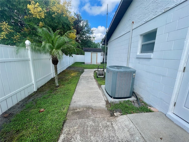 view of yard with a storage shed and central AC unit