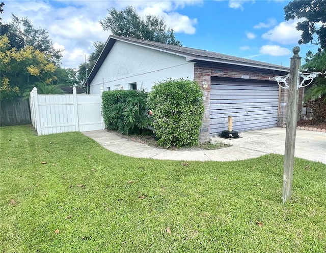 view of property exterior featuring a garage and a yard