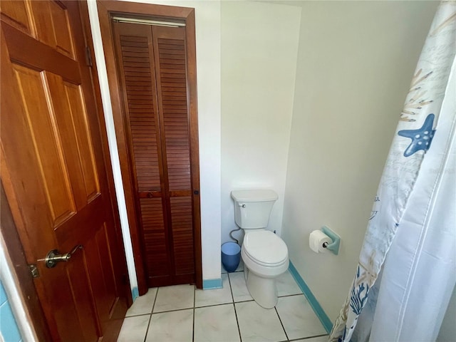 bathroom with tile patterned floors and toilet