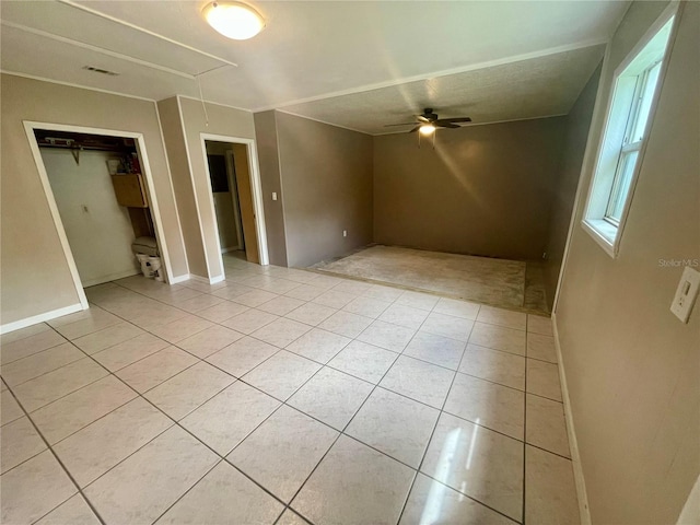 tiled empty room with ceiling fan